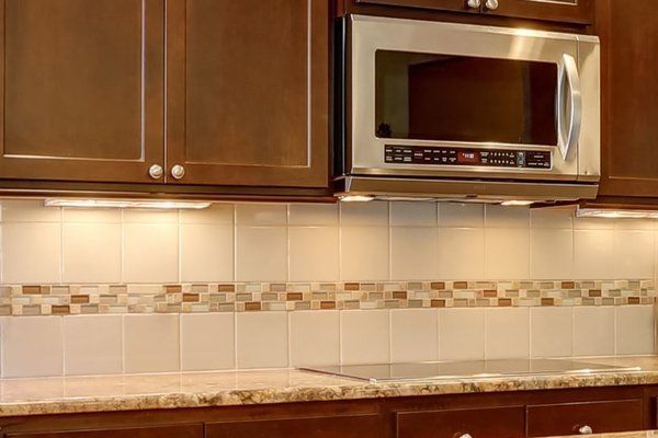 White ceramic and multi-colored glass tile kitchen backsplash