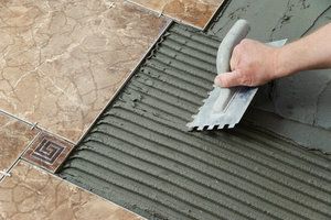 Tile flooring installation process with grout tool