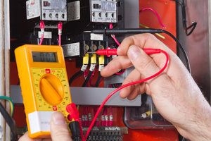 Electrician testing electrical power box
